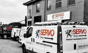 White vans with the servo logo parked outside an office.